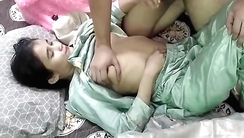 Hot brunette teen in a cute white dress is wearing a silver necklace