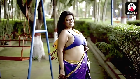 Stunning brunette naked before a mirror in front of a sofa