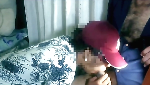 Indian teen posing on a black desk in front of a black computer