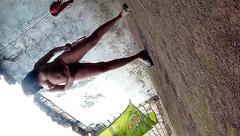 Busty girl 100% nude during solo filming on a grassy field