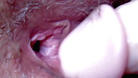 Amateur brunette is doing solo masturbation with a toy