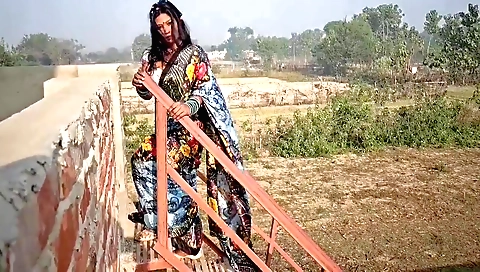 Indian brunette in outdoor with her phone and hair