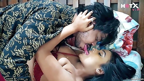 Busty brunette babe on a white sofa is playing her computer