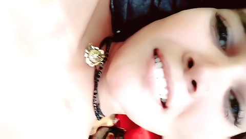 Brunette girl in a red dress and a yellow top is outdoors