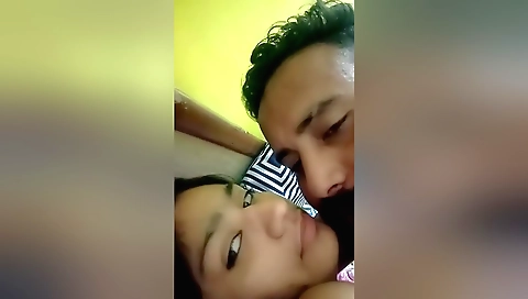 Brunette is making out with a handsome man in her hotel room