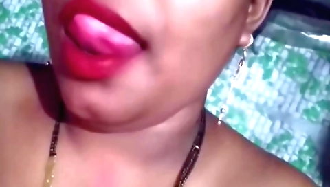 Brunette with big boobs is massaging her tits on a chair